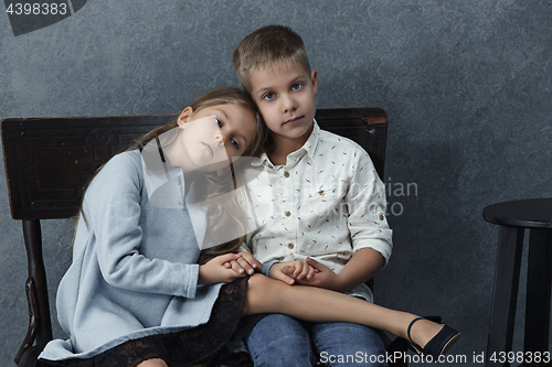 Image of A portrait of little girl and a boy on the gray background