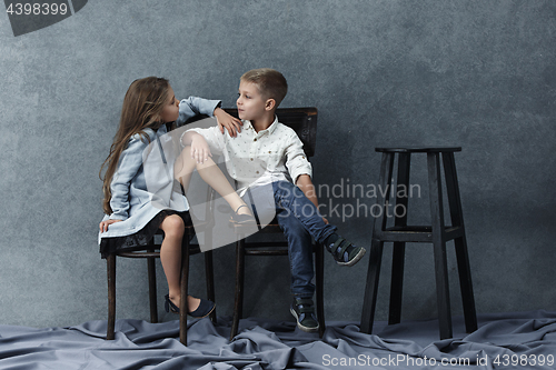 Image of A portrait of little girl and a boy on the gray background