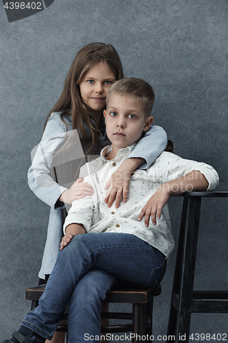 Image of A portrait of little girl and a boy on the gray background