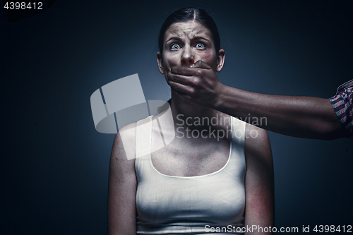Image of Man covering young woman\'s mouth