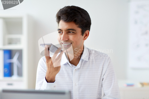 Image of businessman using voice recorder on smartphone