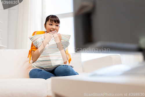 Image of happy asian woman with watching tv at home
