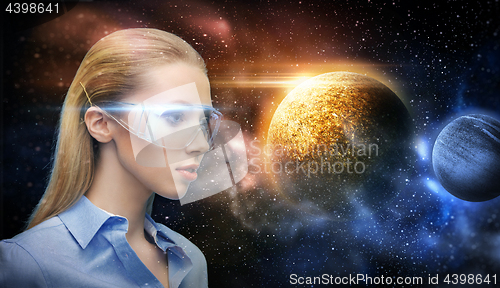 Image of woman in virtual reality glasses over space