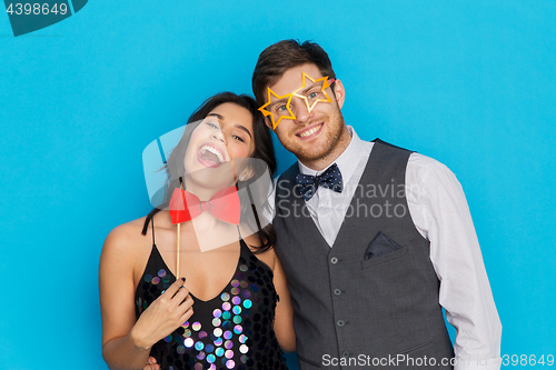 Image of happy couple with party props having fun