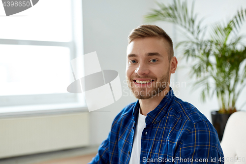 Image of portrait of happy smiling young man at office