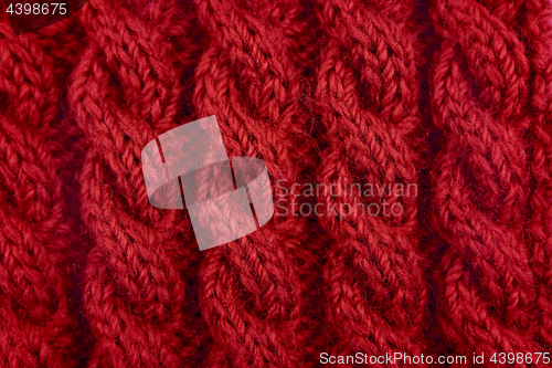 Image of Detail of red cable knitting stitch