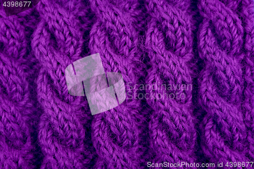 Image of Detail of purple cable knitting stitch