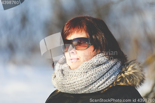 Image of woman with sunglasses without makeup in winter time