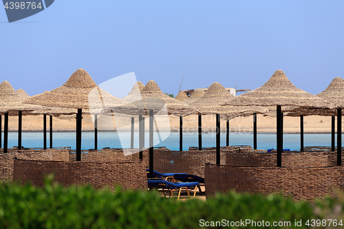 Image of Beach sun parasol and blue sky, holliday in Egypt