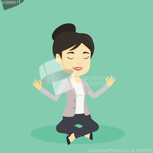 Image of Business woman meditating in lotus position.