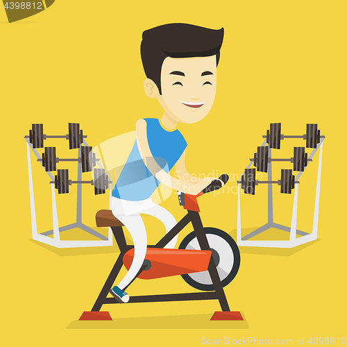 Image of Young man riding stationary bicycle.