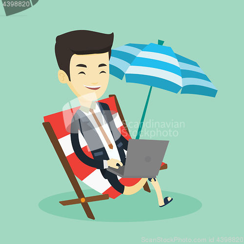 Image of Business man working on laptop at the beach.