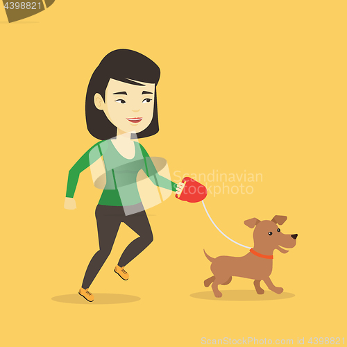 Image of Young woman walking with her dog.