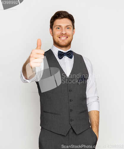 Image of happy man in festive suit showing thumbs up