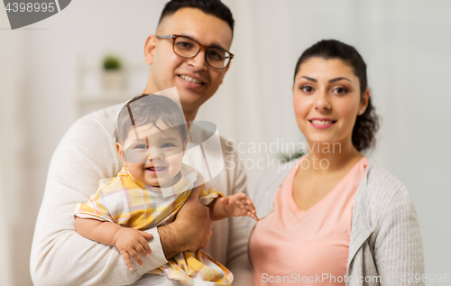 Image of happy family with baby daughter at home