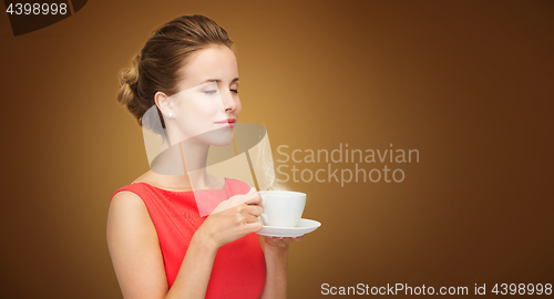 Image of beautiful woman in red dress with cup of coffee