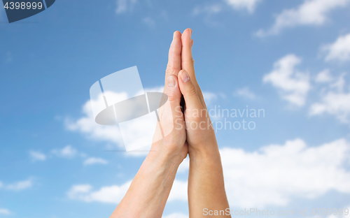 Image of close up of senior and young woman touching hands