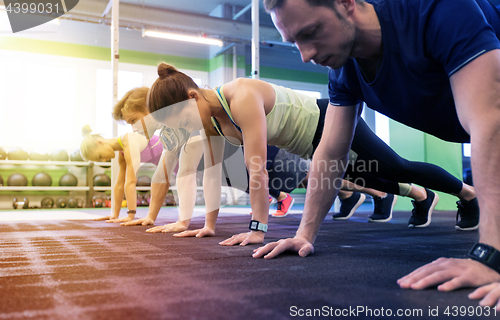 Image of group of people exercising in gym