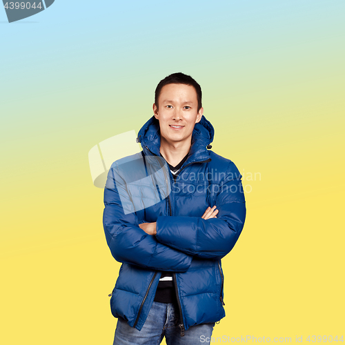 Image of Asian man in blue down-padded coat