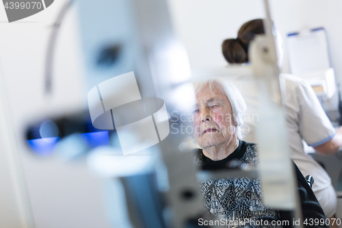 Image of Senior woman beeing prepered for laser surgery at ophthalmology clinic.