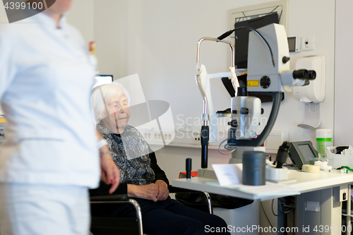 Image of Senior woman beeing prepered for laser surgery at ophthalmology clinic.