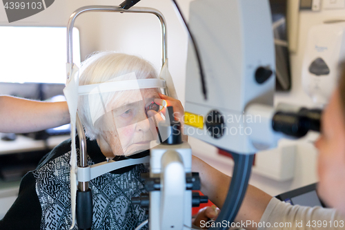 Image of Senior woman during laser surgery at ophthalmology clinic.