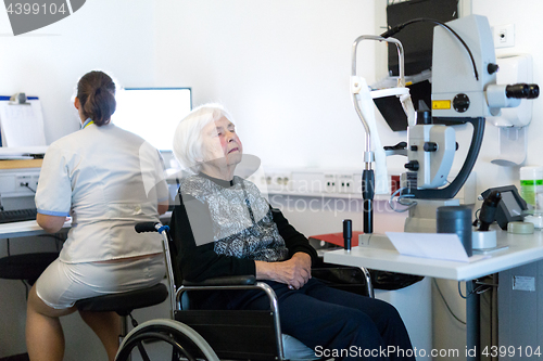 Image of Senior woman beeing prepered for laser surgery at ophthalmology clinic.