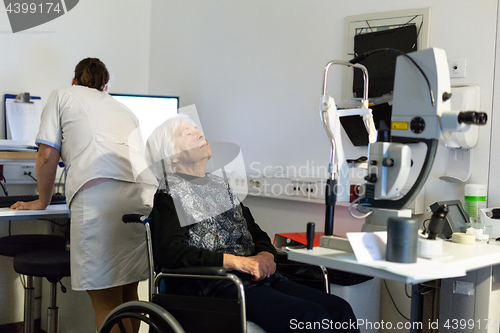 Image of Senior woman beeing prepered for laser surgery at ophthalmology clinic.