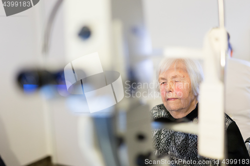 Image of Senior woman beeing prepered for laser surgery at ophthalmology clinic.