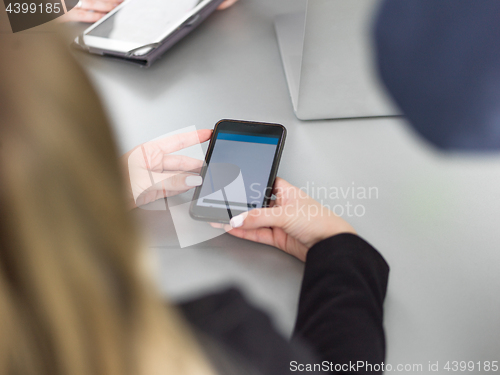 Image of Elegant Woman Using Mobile Phone in office building