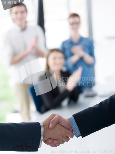 Image of cloasing the deal in modern office interior