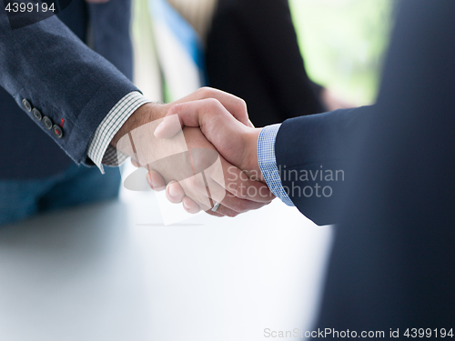 Image of cloasing the deal in modern office interior