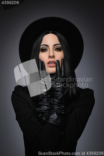 Image of Beautiful High Fashion Model Wearing Black Hte and Leather Glove