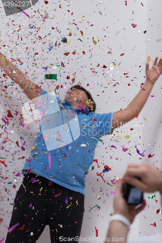 Image of kid blowing confetti