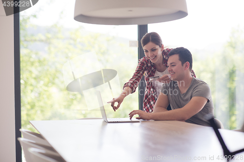 Image of happy young couple buying online