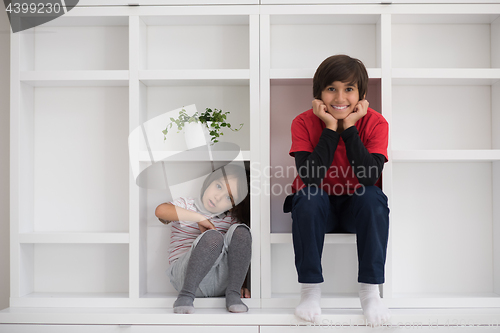 Image of young boys posing on a shelf