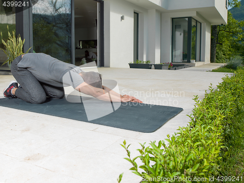 Image of man doing morning yoga exercises