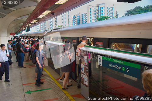 Image of People boarding subway train. Singapore