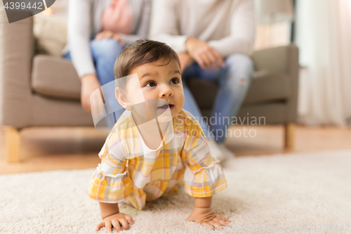 Image of little baby girl on floor at home