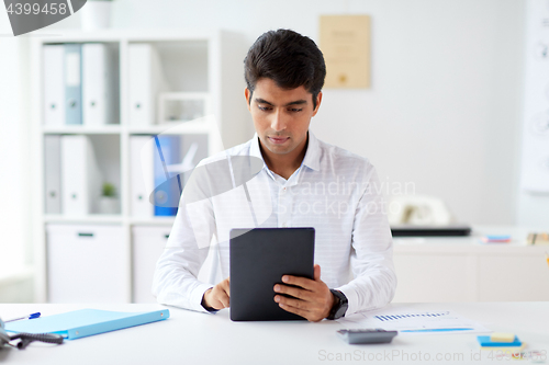 Image of businessman working with tablet pc at office