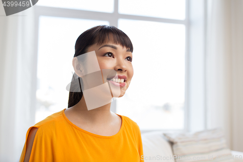 Image of portrait of smiling young asian woman at home