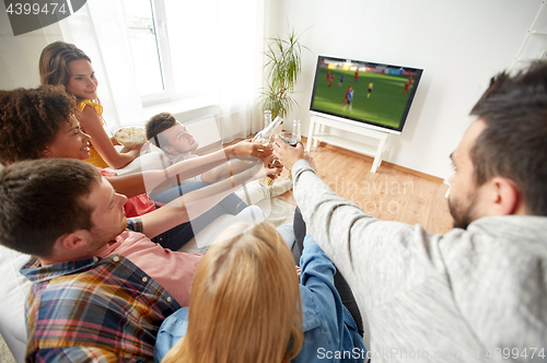 Image of friends with beer watching football or soccer game