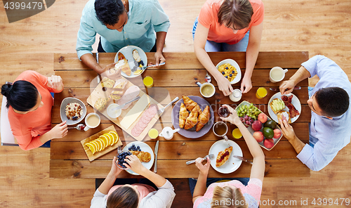 Image of group of people having breakfast at table