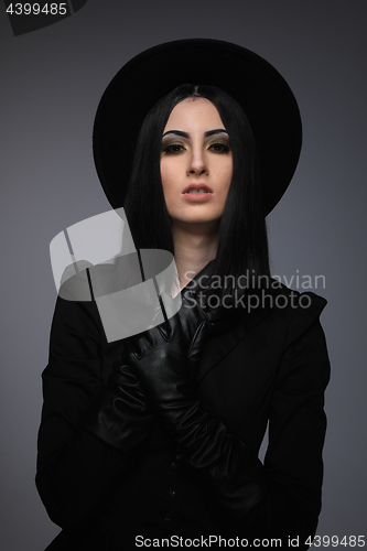 Image of Beautiful High Fashion Model Wearing Black Hte and Leather Glove