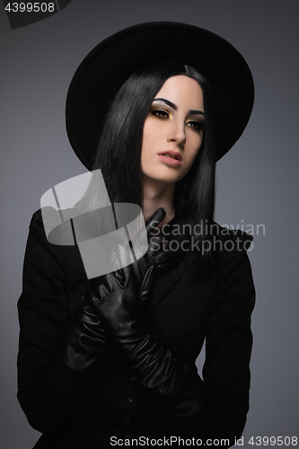 Image of Beautiful High Fashion Model Wearing Black Hte and Leather Glove