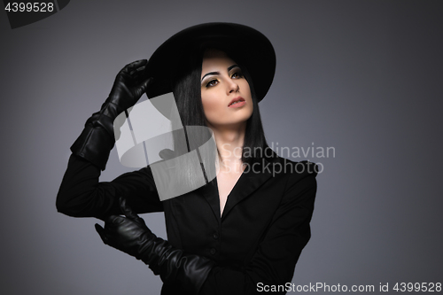 Image of Beautiful High Fashion Model Wearing Black Hte and Leather Glove