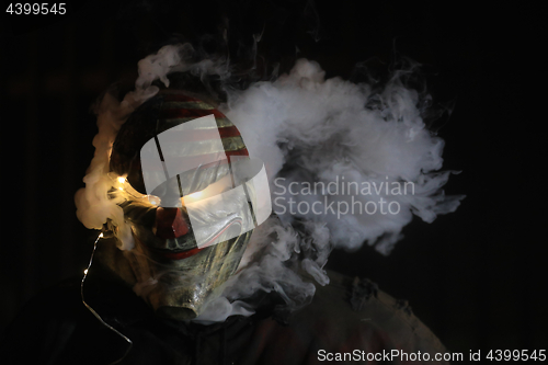 Image of Man Wearing a Mask With Smoke and Lights