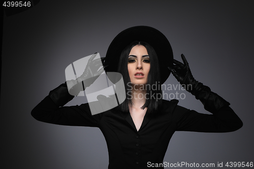 Image of Beautiful High Fashion Model Wearing Black Hte and Leather Glove