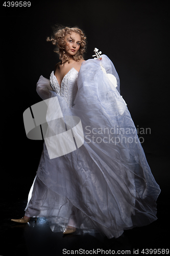 Image of Young Woman In A wedding Dress With A White Violiin