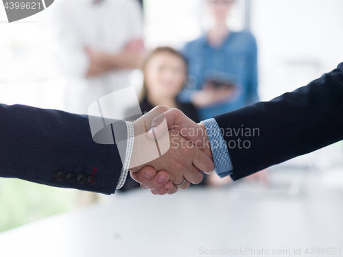 Image of cloasing the deal in modern office interior